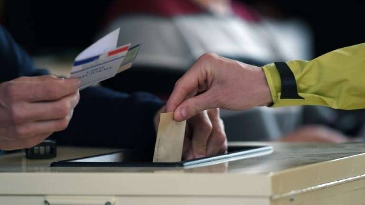 Une personne met son bulletin de vote dans l'urne à Strasbourg le 23 avril 2017. 
