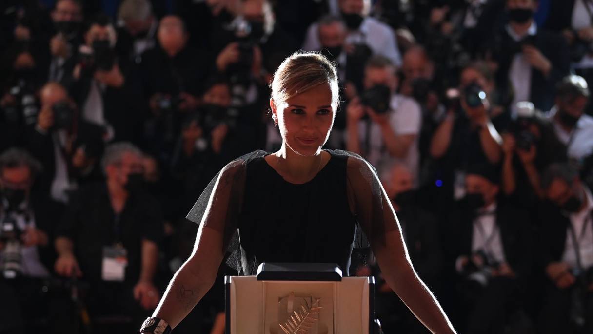 La réalisatrice française Julia Ducournau pose avec son trophée lors d'un photocall, après avoir remporté la Palme d'or pour le film "Titane" lors de clôture de la 74e édition du Festival de Cannes, dans le sud de la France, le 17 juillet 2021.
