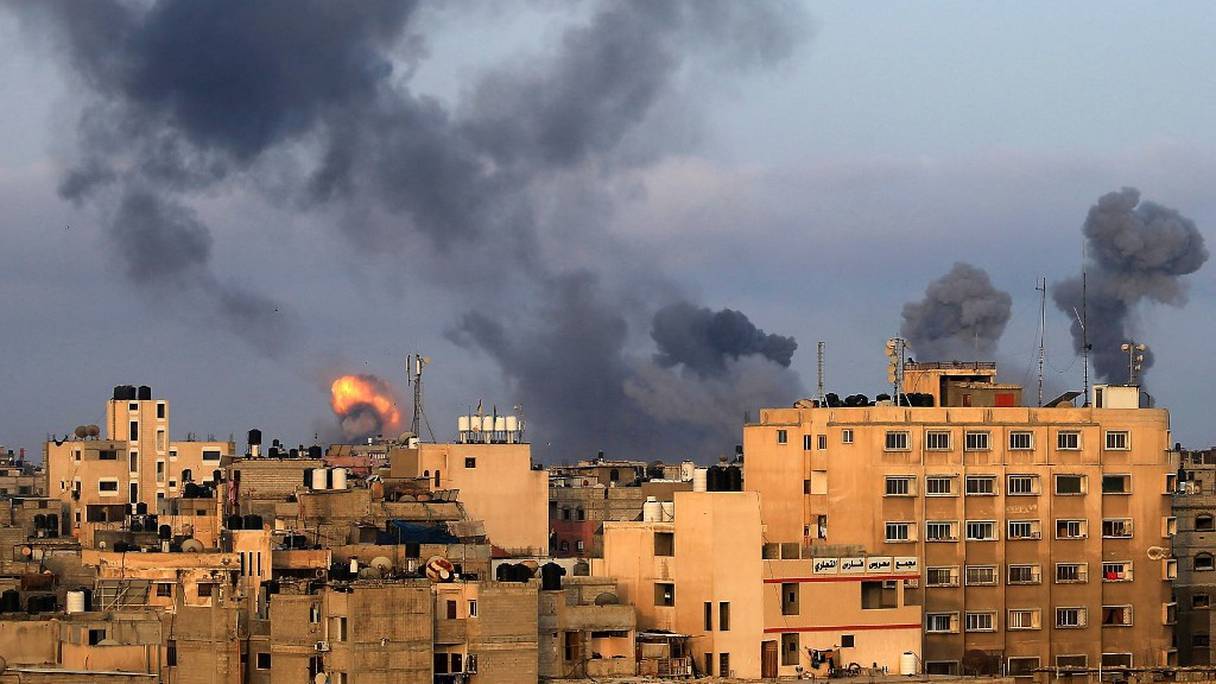 La fumée monte suite à des frappes aériennes israéliennes, en réponse à des tirs de roquettes, dans la région sud de Gaza de Khan Yunès, contrôlée par le mouvement islamiste Hamas, le 11 mai 2021. 
