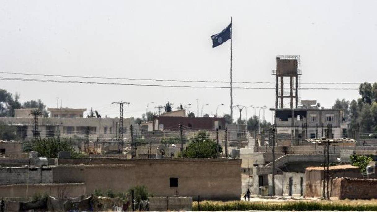 Un drapeau du groupe Etat islamique flotte au dessus de la ville de Tall Abyad, en Syrie.
